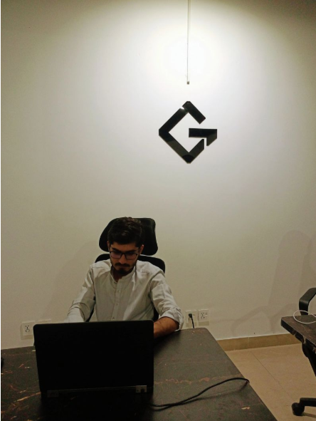 A GrydIn teammate focused on a laptop at the office
