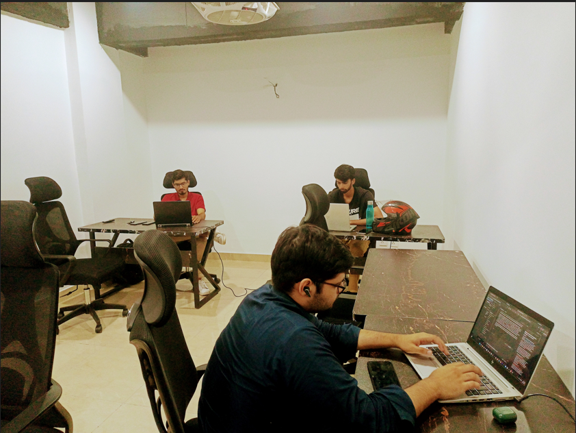 GrydIn teammates collaborating at laptops in the Islamabad office